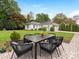 Landscaped backyard with elegant outdoor dining set, lovely lawn and a beautiful white house at 2219 Richardson Dr, Charlotte, NC 28211
