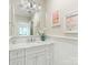 Well-lit bathroom with marble countertop, white vanity, large mirror, and soft, neutral decor at 2219 Richardson Dr, Charlotte, NC 28211
