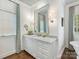 Bright bathroom featuring white vanity with marble countertop and framed mirror at 2219 Richardson Dr, Charlotte, NC 28211