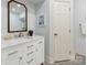 Updated bathroom with a white vanity with marble countertop and a decorative wood-framed mirror at 2219 Richardson Dr, Charlotte, NC 28211