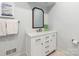 Bright bathroom featuring a white vanity with marble countertop and a decorative wood-framed mirror at 2219 Richardson Dr, Charlotte, NC 28211
