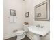 Traditional half bathroom with pedestal sink, framed mirror, and neutral décor at 2219 Richardson Dr, Charlotte, NC 28211