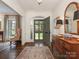 Inviting foyer with hardwood floors, decorative rug, mirror, and views to front yard at 2219 Richardson Dr, Charlotte, NC 28211
