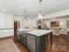 A large kitchen island with stainless steel appliances complements the open concept of this home at 2219 Richardson Dr, Charlotte, NC 28211