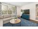 Cozy living room with a blue accent wall and a round center table at 2219 Richardson Dr, Charlotte, NC 28211