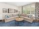 Comfortable living room featuring a large sectional sofa and a bright window at 2219 Richardson Dr, Charlotte, NC 28211