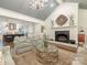 Bright and open living room featuring a fireplace, vaulted ceiling, and kitchen view at 2219 Richardson Dr, Charlotte, NC 28211