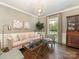 Cozy living room featuring a plush sofa, stylish decor, and large windows with natural light at 2219 Richardson Dr, Charlotte, NC 28211
