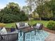 Inviting patio with cushioned seating, table and colorful rug, perfect for outdoor relaxation and entertaining at 2219 Richardson Dr, Charlotte, NC 28211