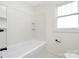 Bright bathroom showcases a clean white bathtub and matching tiled walls at 2230 W 6Th Ave, Gastonia, NC 28052