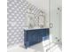Elegant bathroom featuring double vanity, patterned wallpaper, and glass-enclosed shower at 2230 W 6Th Ave, Gastonia, NC 28052