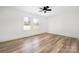 Bedroom with hardwood floors, a ceiling fan, and a view of the backyard at 2230 W 6Th Ave, Gastonia, NC 28052