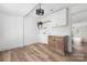 Bright laundry room featuring wood-look flooring, wooden cabinets and drawers, white countertops, and white upper cabinets at 2230 W 6Th Ave, Gastonia, NC 28052
