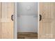 Walk-in closet with built-in shelving and ample storage space with dual sliding doors at 2230 W 6Th Ave, Gastonia, NC 28052