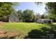A large backyard with mature trees, detached garage, and relaxing fire pit area; perfect for outdoor enjoyment at 2404 Finchley Dr, Charlotte, NC 28215