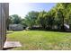 Oversized backyard featuring mature trees, expansive lawn, relaxing fire pit, and additional storage at 2404 Finchley Dr, Charlotte, NC 28215
