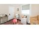 Inviting Bedroom space with comfortable chair, books, and stylish decor at 2404 Finchley Dr, Charlotte, NC 28215
