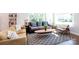This is a bright, naturally-lit living room with two couches and a large area rug at 2404 Finchley Dr, Charlotte, NC 28215
