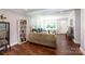 A large, open concept living space with freshly refinished wood floors and light, neutral paint at 2404 Finchley Dr, Charlotte, NC 28215