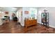 Cozy living area with updated dark wood floors and a built-in bar area off of the updated kitchen at 2404 Finchley Dr, Charlotte, NC 28215