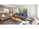 Open concept living room with large windows offering lots of natural light and views of the exterior at 2404 Finchley Dr, Charlotte, NC 28215