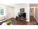 The home's lovely living area features new dark stained wood floors, plenty of natural light at 2404 Finchley Dr, Charlotte, NC 28215