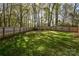 Large fenced backyard with lush green grass and mature trees at 2731 Bishopton Pl, Charlotte, NC 28216