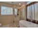 Modern bathroom features walk-in shower, soaking tub, and large window at 2731 Bishopton Pl, Charlotte, NC 28216