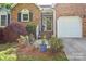 Well-maintained home with brick accents, a cozy entrance, and a two-car garage, surrounded by lush landscaping at 2731 Bishopton Pl, Charlotte, NC 28216