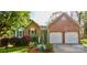Charming brick home featuring an attached two-car garage, manicured lawn, and inviting front entrance at 2731 Bishopton Pl, Charlotte, NC 28216
