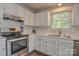 Bright kitchen with white cabinets, modern appliances, and ample counter space for meal preparation at 2731 Bishopton Pl, Charlotte, NC 28216