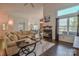Open-concept living area with a fireplace, hardwood floors, a large sectional, and views into the dining area at 2731 Bishopton Pl, Charlotte, NC 28216