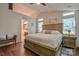 Bedroom with tray ceiling and ensuite bathroom with a lovely hardwood floor at 2731 Bishopton Pl, Charlotte, NC 28216
