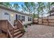 Backyard with wooden fence and deck with stone patio and plants at 2749 Old Nation Rd, Fort Mill, SC 29715