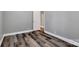 Neutral bedroom with laminate flooring, freshly painted walls, and an open door at 2749 Old Nation Rd, Fort Mill, SC 29715