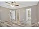 Neutral bedroom with ceiling fan, light gray walls, and bathroom and closet entrances at 2749 Old Nation Rd, Fort Mill, SC 29715