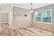 Inviting dining room featuring ample natural light from two windows and stylish wood flooring at 2749 Old Nation Rd, Fort Mill, SC 29715