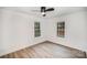 Bright bedroom features two windows, ceiling fan, and neutral paint to create a relaxing space at 308 Birch St, Lowell, NC 28098