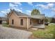 Charming single-story home featuring a covered entryway, complemented by a gravel driveway and tidy yard at 308 Birch St, Lowell, NC 28098