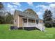 Quaint home with a covered front porch and well-maintained lawn at 308 Birch St, Lowell, NC 28098