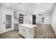 Modern kitchen featuring a central island, gray cabinetry, and a pass-through door to the back at 308 Birch St, Lowell, NC 28098