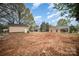 Wide view of property showing house and detached garage on a large lot perfect for outdoor living at 308 Birch St, Lowell, NC 28098