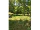 Expansive backyard surrounded by mature trees, offering a private and serene outdoor space at 311 33Rd Street Se Dr, Hickory, NC 28602
