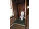 Modest bathroom featuring green tile flooring, brick wall, and standard fixtures at 311 33Rd Street Se Dr, Hickory, NC 28602