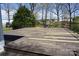 Large deck with unfinished wood planks, surrounded by lush trees offering space for relaxing at 311 33Rd Street Se Dr, Hickory, NC 28602