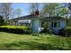 Charming single-story home with mature landscaping and a well-maintained lawn at 311 33Rd Street Se Dr, Hickory, NC 28602