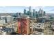 Scenic aerial view showcasing the reflective glass high-rise, Charlotte skyline and surrounding urban landscape at 315 Arlington Ave # 705, Charlotte, NC 28203