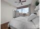 Serene bedroom with natural light, balcony access, and simple decor for a peaceful retreat at 315 Arlington Ave # 705, Charlotte, NC 28203