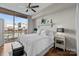 Bright bedroom featuring a balcony with city view, soft decor, and a ceiling fan at 315 Arlington Ave # 705, Charlotte, NC 28203