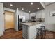 Eat-in kitchen with modern stainless appliances, beautiful granite countertops, and hardwood floors at 315 Arlington Ave # 705, Charlotte, NC 28203